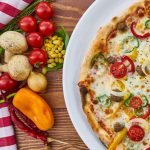 Cheesy pizza with tomatoes, cherry at top